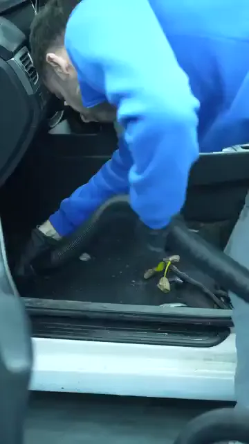Kapı açık, taban döşemesi kaldırılmış halde araç içi hortumla süpürülüyor; eşik kenarında kalan artıklar tek tek alınıyor.

Dört saniyelik kesitte ses ve yazı bulunmuyor, işlem yalnız görüntüden okunuyor.
