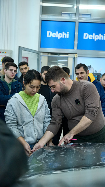 Ege Üniversitesi söyleşimizde bir öğrenci kaputa PPF filmini kendisi uyguluyor, Lokman İn yönlendiriyor.